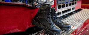 Magnum Strike Force boots displayed on front bumper of fire truck